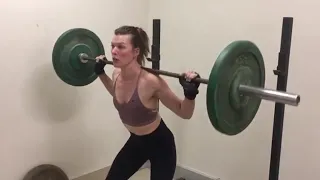 Milla Jovovich lifts a barbell