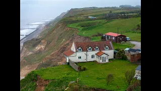 Norfolk house dangling over cliff to be demolished.