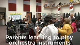 Parents learning to play orchestra instruments
