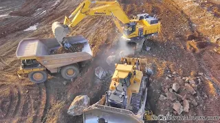 Komatsu PC1250 Excavators loading Cat 777F Haul Trucks on rocky residential project