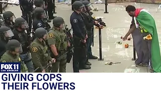 UC Irvine protests: Man in Palestine flag leaves flowers for police in riot gear