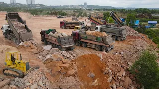 Nice Operation Team Work Filling Land by Bulldozer Spreading Stone and many Dump Truck Loading Stone