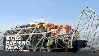 Workers begin to cut and remove Key Bridge debris