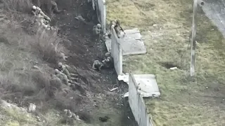 Ukraine - Ukrainian troops fire at a Russian infantry unit with a heavy machine gun. Drone footage
