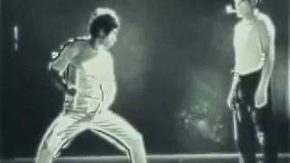 Bruce Lee Lighting Matches with Nunchucks