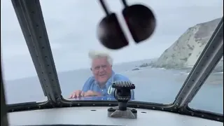 Jay Leno appears from the nose hatch of a Grumman Albatross in Santa Catalina
