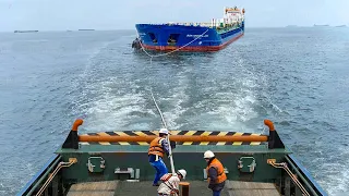 A Day in the Life of a Tiny But Powerful Tugboat Towing Gigantic Ships at Sea