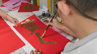 Calligrapher keeps Lunar New Year tradition alive in Bangkok's Chinatown | AFP