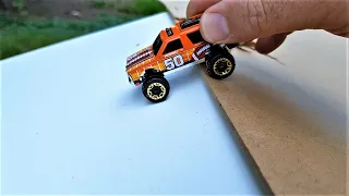 Hot Wheels cars slide down the board