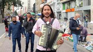 A Colombian guy is performing a folk Ukrainian song in the middle of Bogota