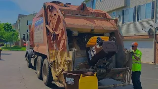 2 Orange MDC Autocar McNeilus Garbage Trucks on Recycle Cart Lines