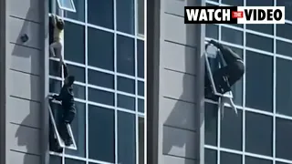 Heart-stopping moment neighbour risks his life to save toddler dangling from window