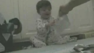 The Baby Laughing at paper