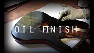 Applying oil finish on ebony guitar top and mahogany body