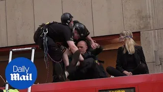 Authorities arrest climate change protesters glued to London train