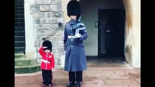 Boy Dressed as British Guard Salutes Windsor Castle Soldiers