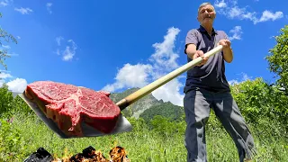 Rustic steak fried on a Shovel in Oil! Picnic in Nature