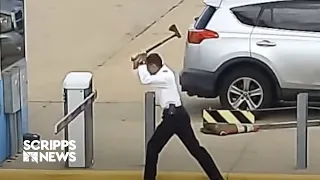 RAW FOOTAGE: Pilot caught on surveillance video taking ax to parking gate