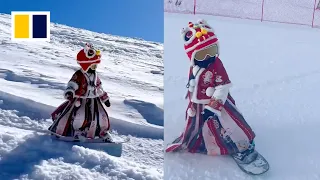 4-year-old showcases snowboarding skills in Chinese hanfu