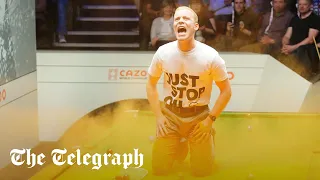 Just Stop Oil protester storms table at World Snooker Championship