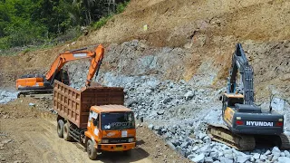 Kelok 18 Road Construction Doosan DX300LCA Excavator Loading Rocks Into Dump Trucks