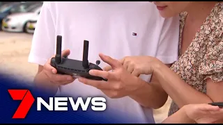 Teenager using a drone spots great white shark near swimmers at NSW beach | 7NEWS