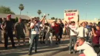 Protesters gathered outside a Phoenix mosque on Friday as police kept the two groups sparring about