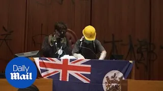 Protestors unveil British colonial flag in Hong Kong legislature