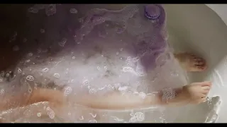 Girl Relaxing in the Bath Tub