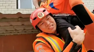 'Sit on my shoulder!' Firefighters rescue stranded old man as floods hit east China