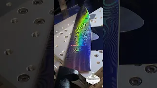 Engraving a holographic rainbow "Damascus" pattern onto a chefs knife.