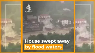 Village house collapsing by flood waters