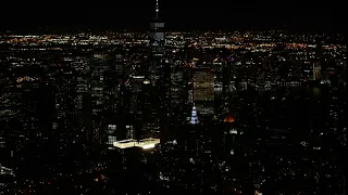 Night aerial view of One Manhattan Square with a pan up to lower Manhattan
