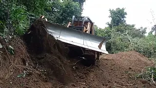 Caterpillar D6G Bulldozer Makes Road in  Mountain For Plantation Road