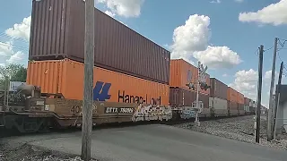 A trio of Norfolk Southern AC44C6M locomotives hauling a northbound doublestack intermodal train.