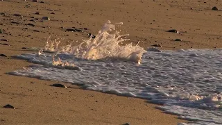 Relax - Calm sea waves moving the pebbles on the beach sand