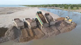 Beautiful Job and place skillfully Bulldozer and Dump Trucks Filling land into the sea,