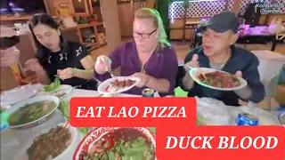 American woman eat Duck Blood with Lao friends. Lao pizza & grilled BBQ. Lao food