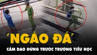 Công an khống chế người đàn ông cầm dao đứng trước trường tiểu học nghi ngáo đá