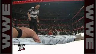 Big Show chokeslams The Undertaker through the ring