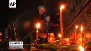 Mourners gather at a memorial to victims of the Chernobyl disaster to mark the 29th anniversary of t