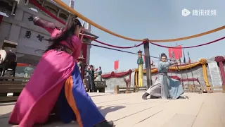 Kung Fu girl dominates the ring and looks down on the boy, only to be subdued by him in one move.