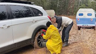 WE WEAR SNOW CHAINS AT THE MUDDEST CAMPING PLACE
