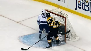 Puck amazingly doesn’t go in after Tyler Johnson crashes into Tuukka Rask