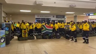 South African firefighters sing and dance after arriving at Edmonton's airport