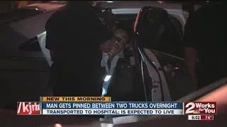 Man pinned between cars