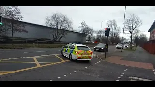 police car leaving wigan police station 31st January 2024