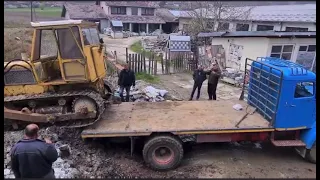 loading a bulldozer onto a truck