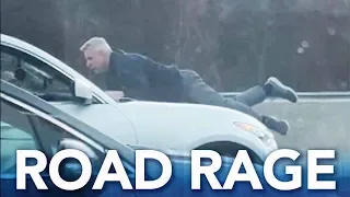 Road rage: Man clings to moving SUV on highway