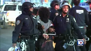 Police officers arrest anti-war protesters in New York